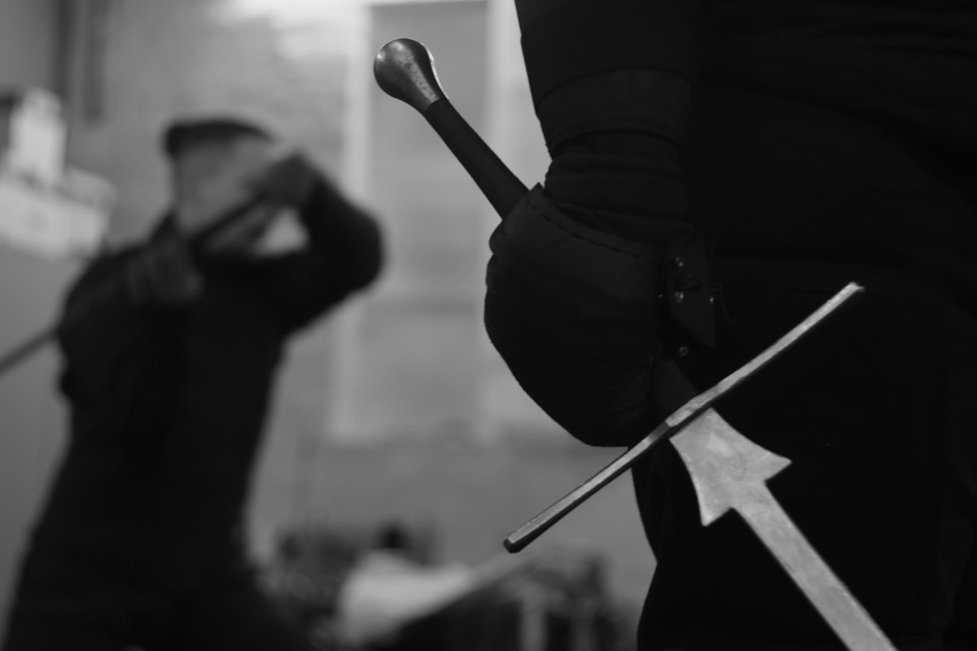 Two Atira Ruthenia fencers with longswords during a HEMA training session